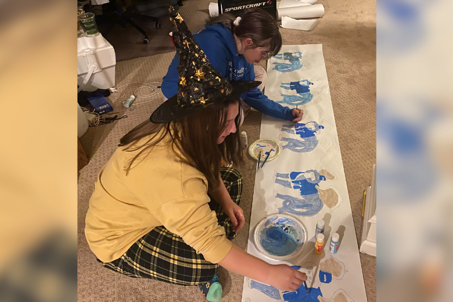 Senior Samantha Haney and sophomore Lily Brown spend after school time working on the Lafayette Theater Companys parade float by painting one of their banners. Their float will be displayed in the Homecoming parade Sept. 22. 