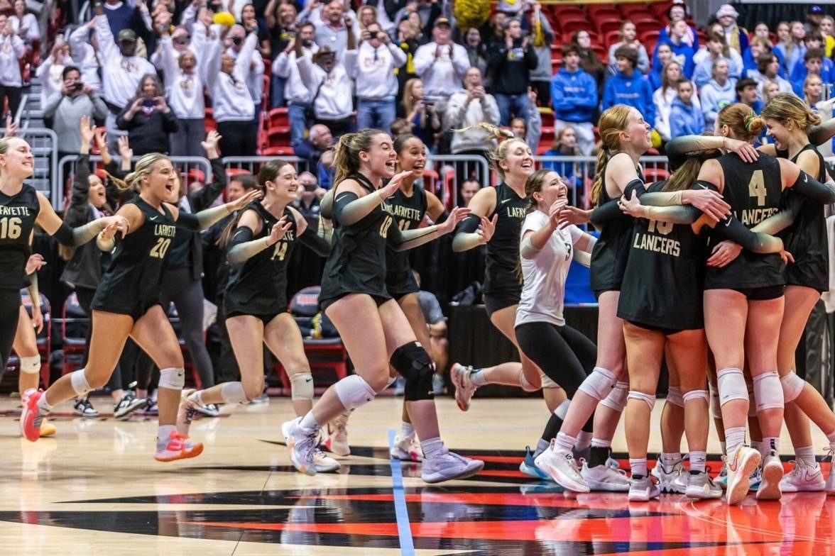 After their State victory on Nov. 4, the volleyball team celebrates on the court.  The team defeated Francis Howell in straight sets, 3-0. Everyone was out-of-this-world excited. [Winning back-to-back] was something that hasnt happened in awhile, Nelson said.
