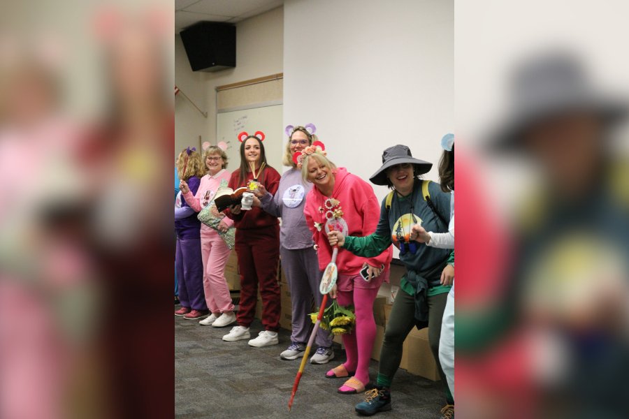 Dressed up as a department, the Guidance and Counseling Department enjoys the music at the staff Halloween event. The department dressed up as self-care-bears, representing the care they have for students. 