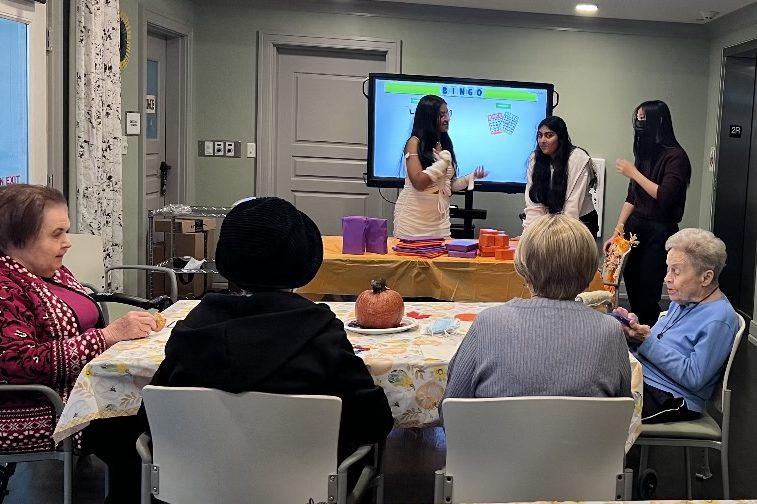 While+volunteering+at+Anthology+Senior+Living+in+Town+Center%2C+sophomore+Sakhi+Lal+with+her+sophomore+team+members+Christina+Boniface+and+Michelle+Chen+play+Halloween+Bingo+with+the+elders.+Lal+said+that+the+reason+she+started+her+nonprofit+organization%2C+Serving+the+Seniors+%28STS%29%2C+is+because+she+used+to+volunteer+in+senior+homes+and+saw+how+much+support+they+needed.+%E2%80%9CI+used+to+volunteer+at+Anthology+of+Town+and+Country+and+I+realized+that+the+residents+need+a+lot+of+support+financially.+Theyre+pretty+sad+and+depressed+there+and+they+feel+really+trapped.+That+really+got+to+my+heart+and+I+want+to+get+as+many+people+to+volunteer+at+these+senior+homes+to+help+these+elderly+people+to+where+they+dont+feel+alone+and+they+feel+like+they+have+someone+that+is+there+to+support+them%2C%E2%80%9D+Lal+said.
