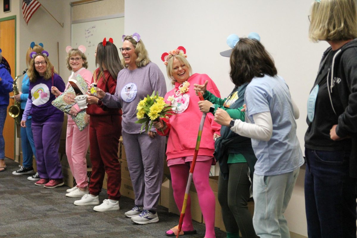 Dressed up as a department, the Guidance and Counseling Department enjoys the music at the staff Halloween event. The department dressed up as Self-Care-Bears, representing the care they have for students. 