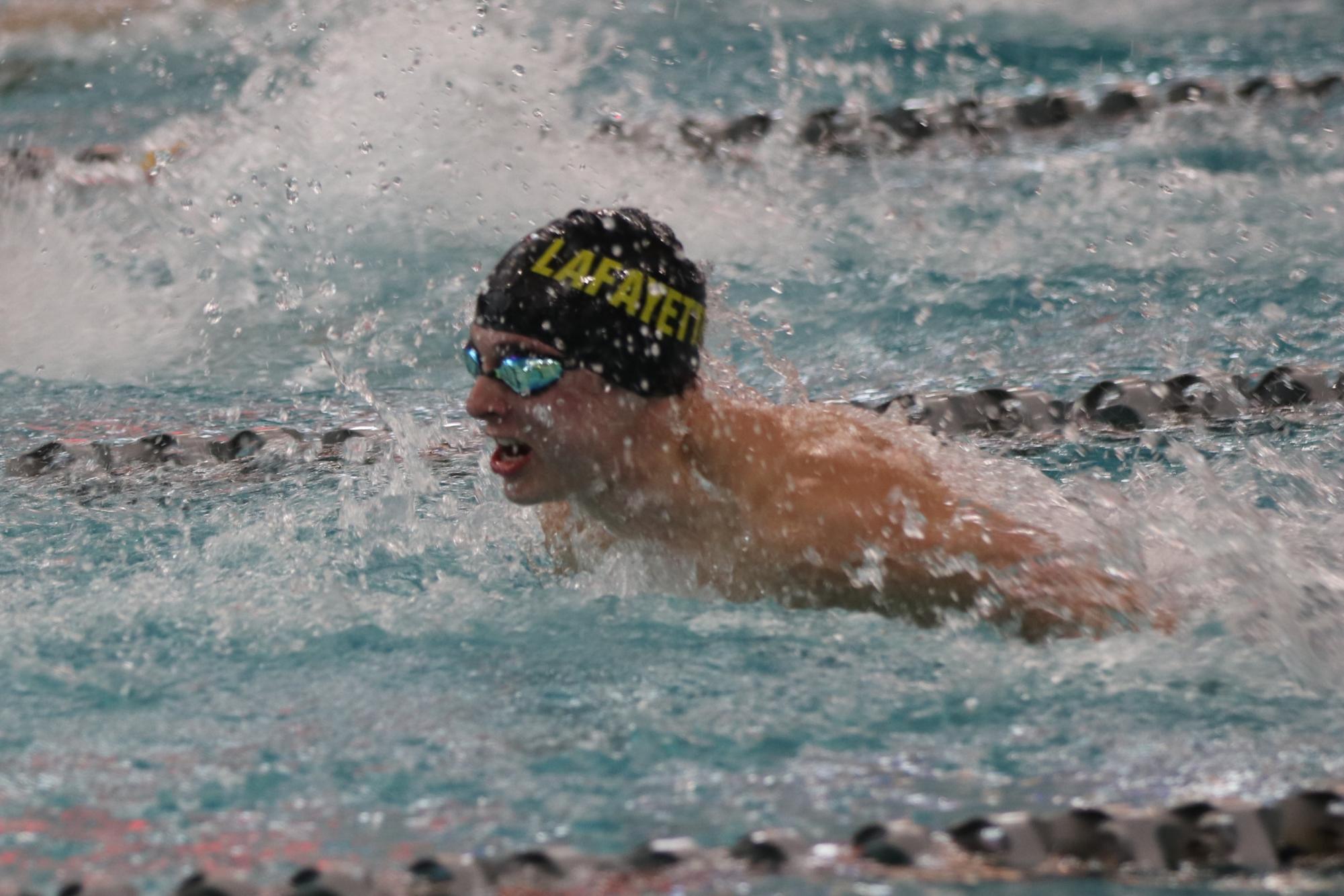 In the individual medley, senior Caleb Warner glides through the water with his butterfly stroke. Warner became a State Champion in the 200-meter individual medley and the 100-meter breaststroke. 