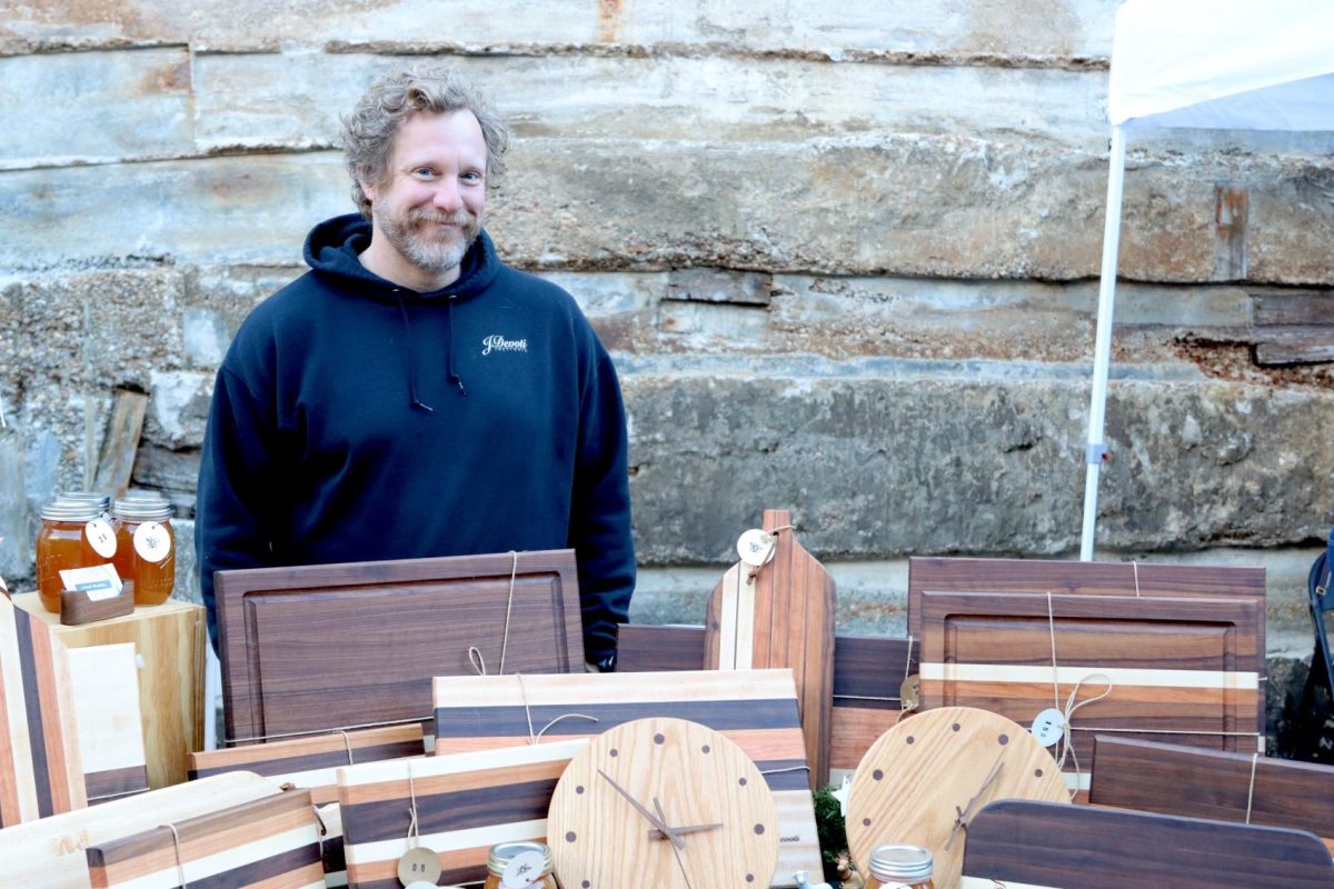 Anthony Devoti, owner of J. Devoti Woodshop, stands behind his booth. Devoti spends up to three days creating each product.