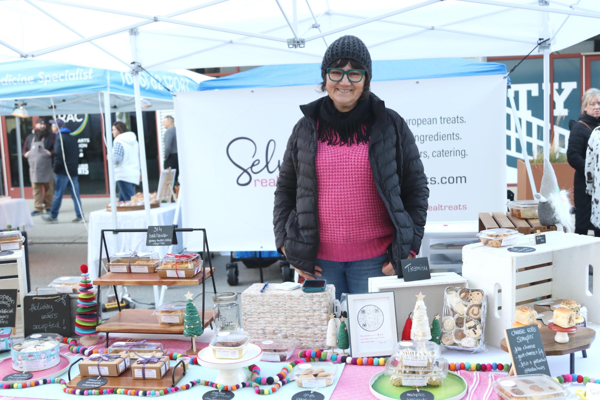 Selma Muminovic stands behind her booth, Selmas Real Treats. Muminovic makes all her baked goods by hand and theyre inspired by her time in Europe.