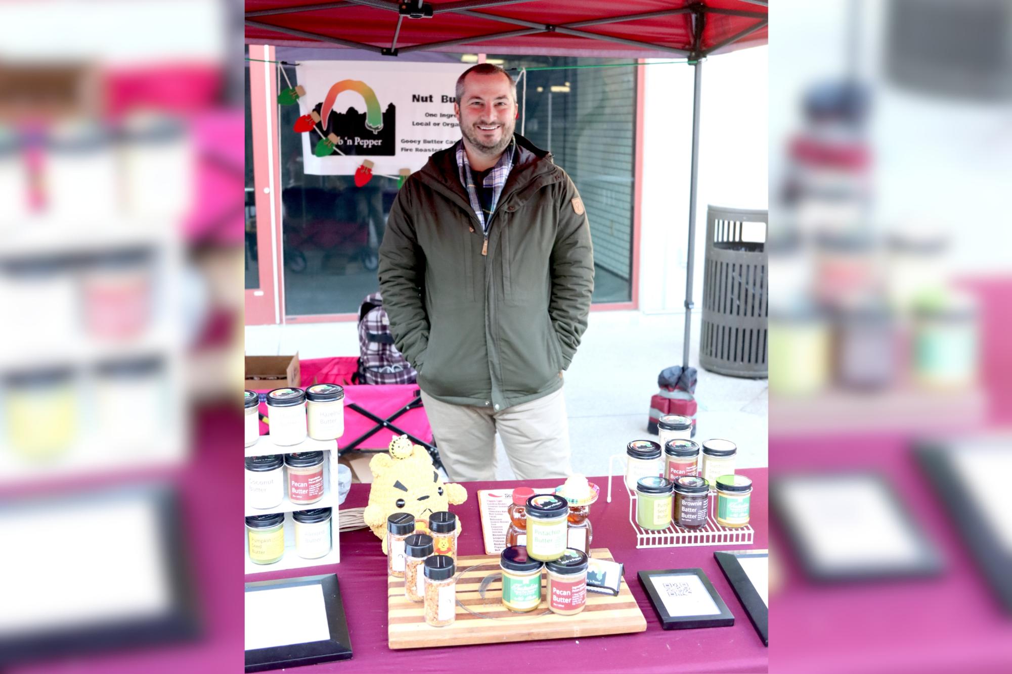 Herb N Pepper owner Anthony Lynch stands behind his booth. He has been running his business for two years and sells mainly through farmer markets.