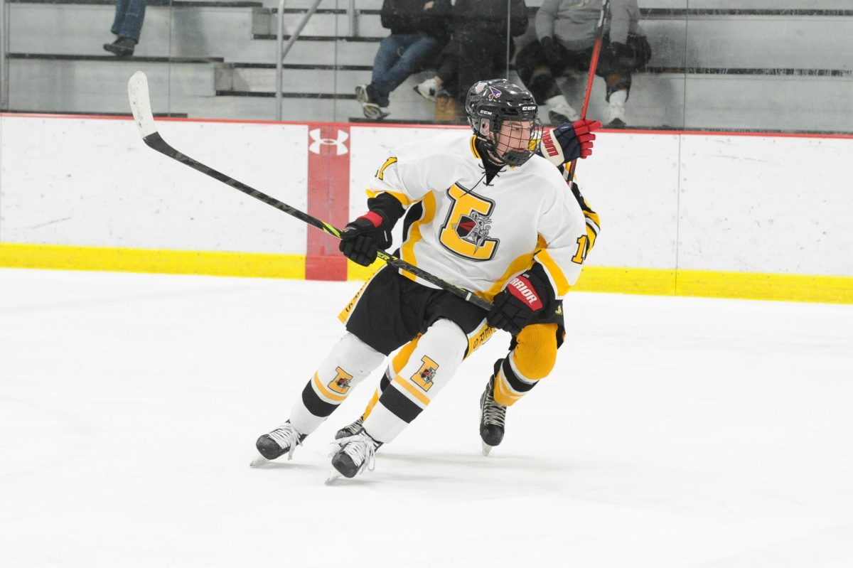 Wearing his neck guard, junior Matthew Ridgeway skates away from his defender. Ridgeway was happy to wear a neck guard once Lafayette required it. “You never know whats gonna happen, so you should wear a neck guard,” Matthew said.