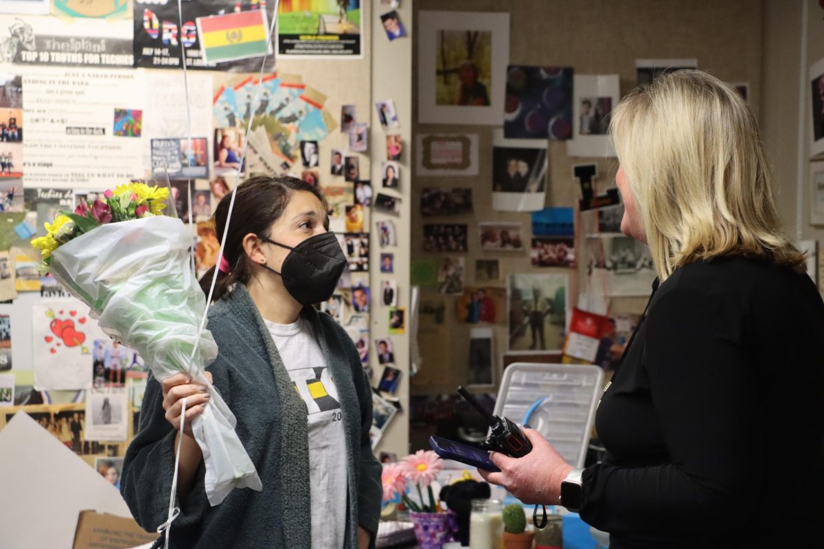 Principal Karen Calcaterra surprises Natasha Fischer with flowers and a balloon Feb. 7, 2022 after she was selected as Teacher of the Year. The following year, she left LHS to become an Administrative Intern at Kellison Elementary.