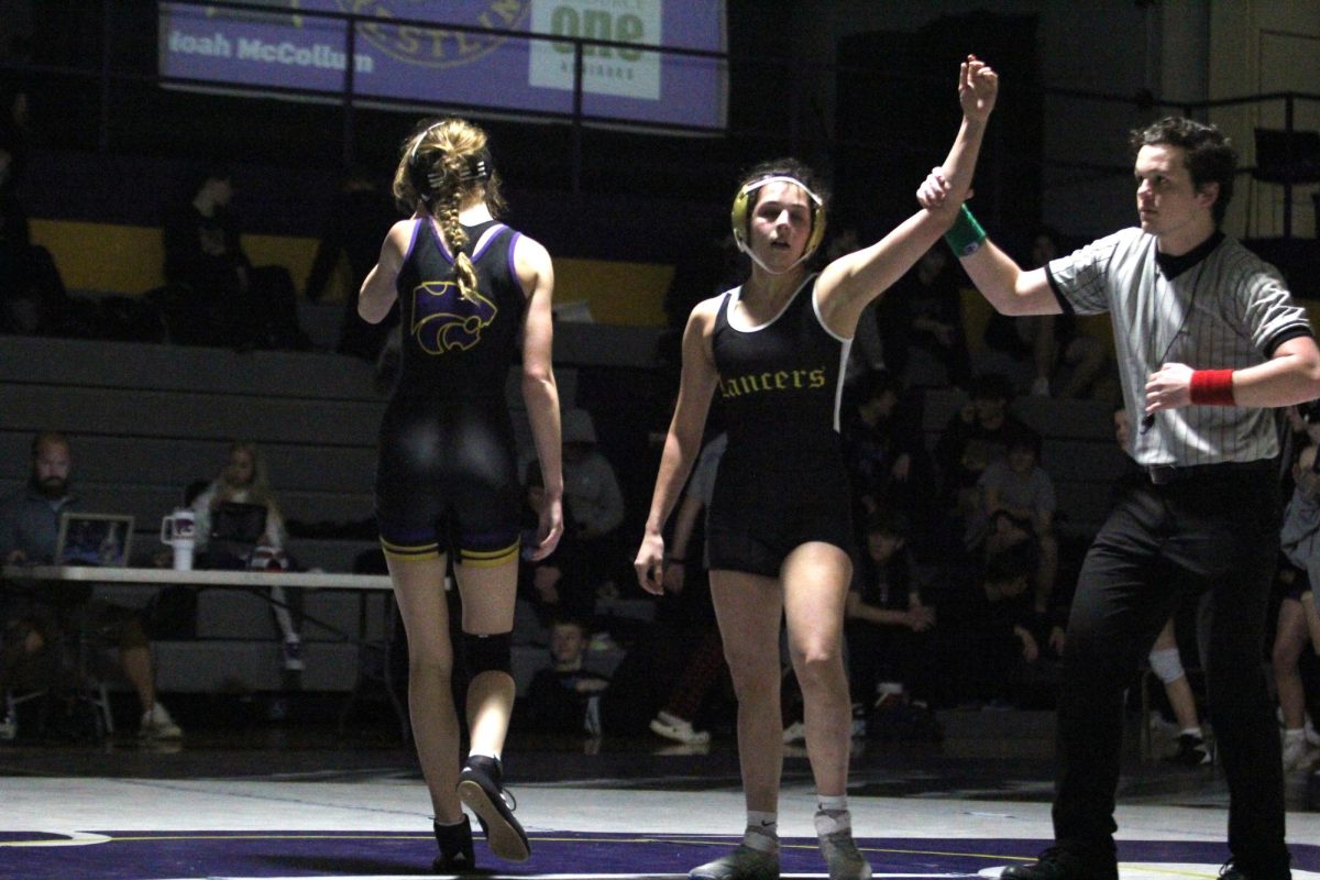 After beating her Eureka opponent, senior Mera Flores holds her hand up in victory. Flores also finished 2nd in the Lindbergh Invitational later that week. Flores believes shes grown as a wrestler this season. I think [Ive improved]. I feel like Im more confident when Im taking shots, going for a takedown, Flores said. 