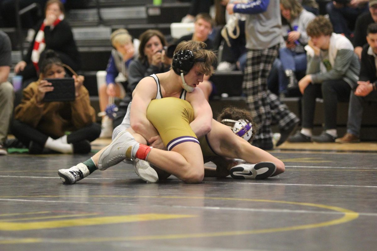 Bringing his opponent down to the mat, senior Dylan Roth wraps his arms around a CBC wrestler during the MSHSAA District Tournament. Winning his 150th match, Roth finished 1st in Districts. Roth will be competing at State Feb. 23-24.
