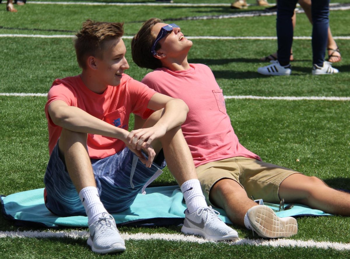Sitting on a blanket on the field, Lafayette graduates Justus Carlile and Kyle Radecki get ready as the sun starts to fade during the 2017 eclipse. It was cool to see it go all black. It was something I have never seen before, Radecki said.