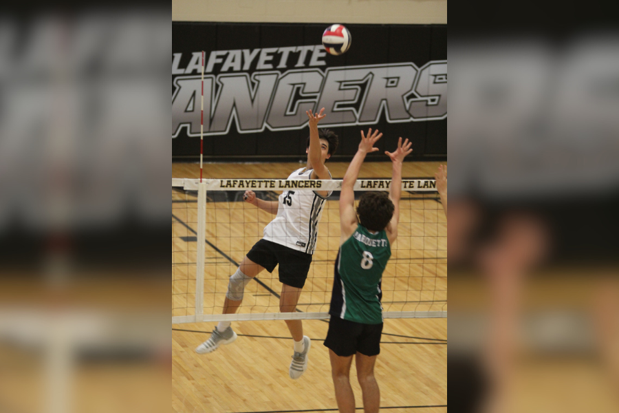 With his eyes locked on the ball, senior Lucas Tran rises for the kill. Tran was 1st Team All State last year. 