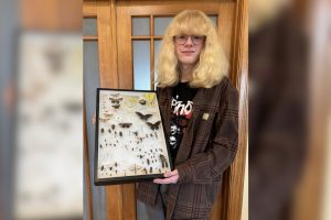 Sophomore Gus Nagel holds a display case with a variety of specimens with the order labeled inside the case. "This is my first full display that I made, all of the specimens I caught myself within the span of about a year," Nagel said.