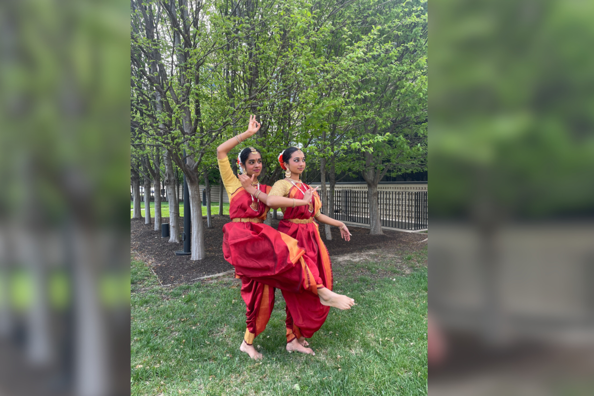 In a routine based off of the Hindu gods Krishna and Radha, sophomore Hritika Malugu and Brentwood High School freshman Meenakshi Kadungath strike a pose. Malugus favorite routine is also based off of Krishna. My favorite dance piece is probably Asainthadum which is a classical piece about how everyone is happy when Krishna is around. It’s really dynamic and has a lot of fun steps, Malugu said.