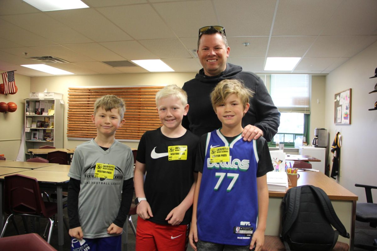 Language arts teacher Donald Kreienkamp brought his two sons, Isaiah (left) and Ari (right) to Lafayettes first annual Bring Your Kid to Work Day. Secretary Amy Danner also brought her son Ryan (middle). Ari said he was excited to miss school because he didnt have to take the MAP test.