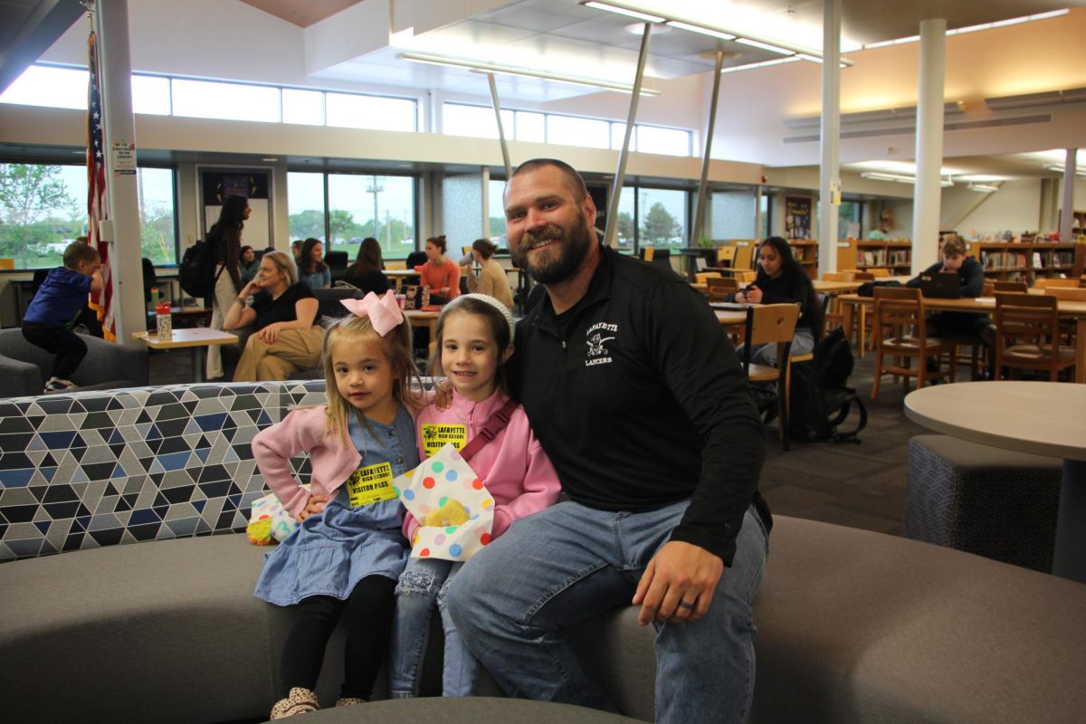 To kick off the day, donuts were offered in the Library before school for staff members and their kids. Social studies teacher Tim Yeargain brought his two daughters, Maddie and Ellie. Im excited they get to finally see [my] day in the life, Yeargain said.