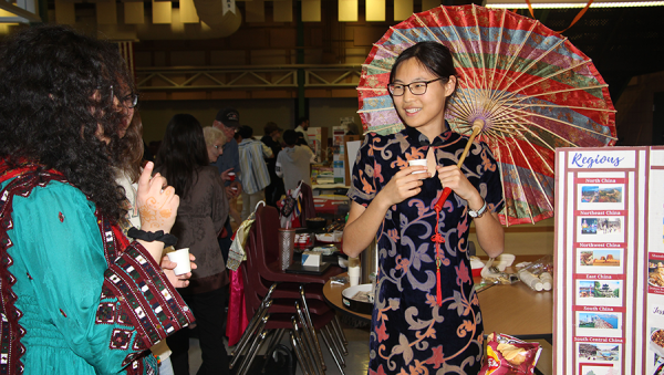 Jessica Guan who is representing China, is talking about her stand. International Day featured many booths for different countries.