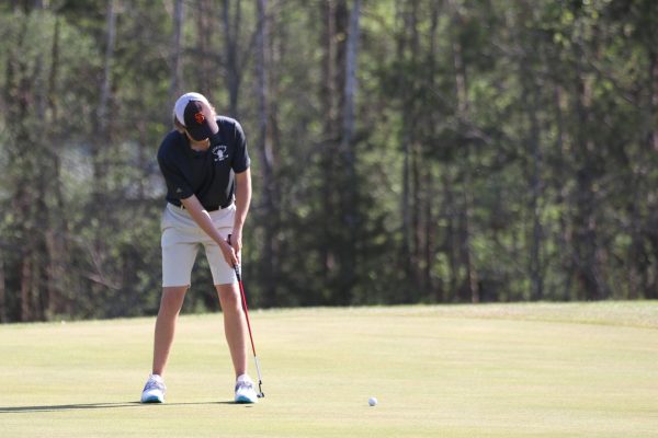 Junior Conner McCown putts during the Webster Cup Invitational tournament. McCown placed 13th with a round of 77.