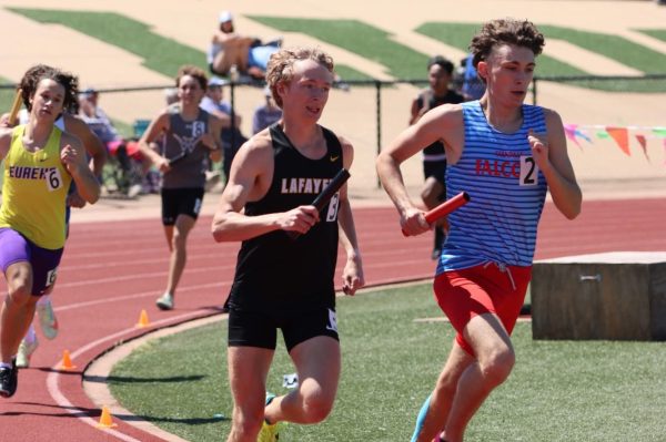 Senior Dillion Cronin runs after receiving the baton in the 4x800-meter relay. The 4x800 team ran a 7:59.24 and finished 2nd place. They look to compete in the State Meet next weekend.  