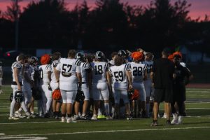 At the end of the night, varsity football players huddle with Coach Boyd Manne. The Lancers first game is at 7 p.m. Aug. 30, at Parkway North.