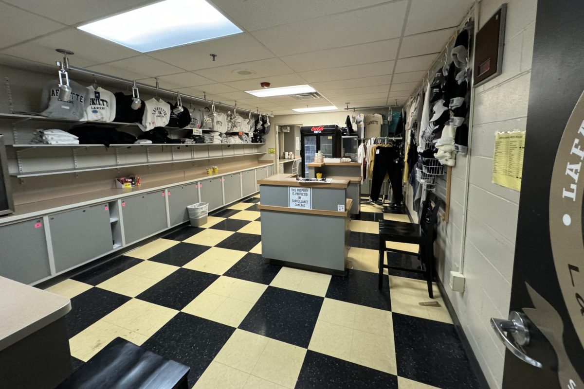 Prior to the renovation, the school store featured a large circulation desk in the middle of the room, sliding-door cabinets along the walls and shelves of spirit wear around the entire room.