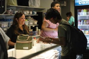 In the renovated school store, junior Mahanth Samala purchases a protein shake from a parent volunteer. WiFi problems prevented card transactions from working, but LPO hopes they will be up and running soon.