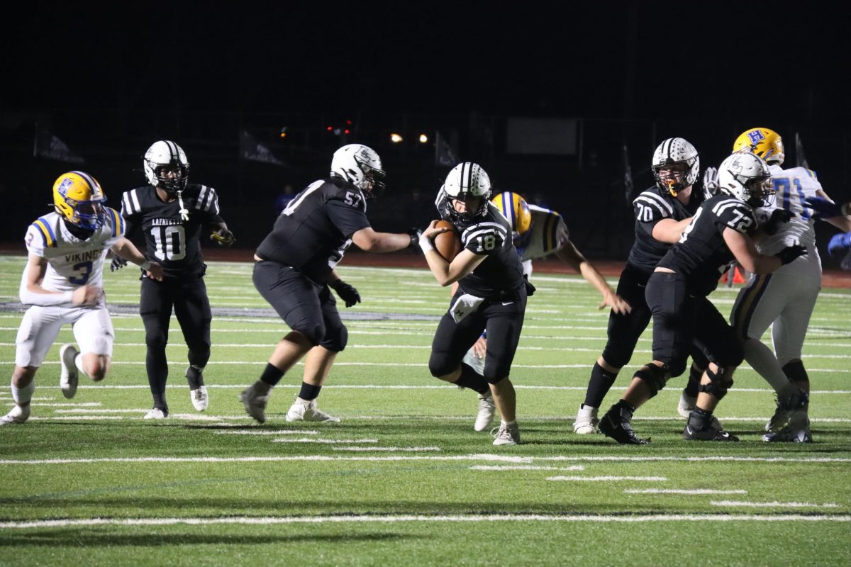 Senior Jack Behl leaves the pocket and runs the ball against Francis Howell November 3, 2023. Jack along with Seniors Robby Preckel, Alex Behl and Nate Hutchison will be players to watch this season, according to Head Coach Boyd Manne.
