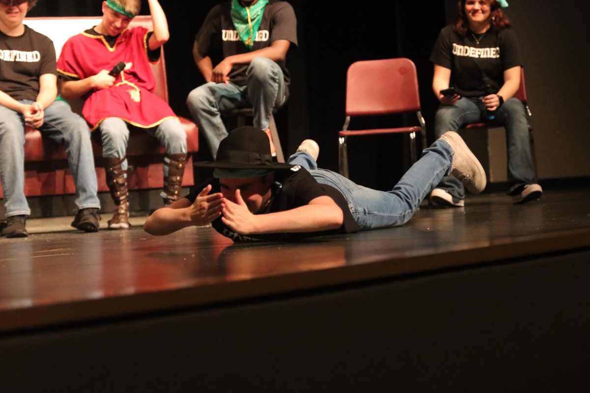 Laying on the ground as a walrus, senior captain Evan Sommer enters a scene of "Minute to Win It" set in Antarctica.