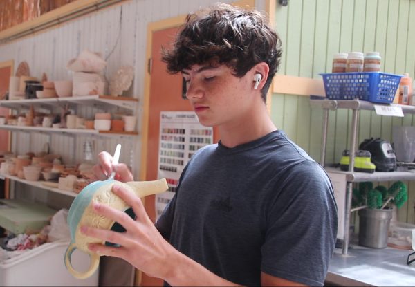 Junior, Luke Hinton, working at his studio, Wildwood Green Arts, located in Glencoe, MO. He has been going there for ceramics for a year.