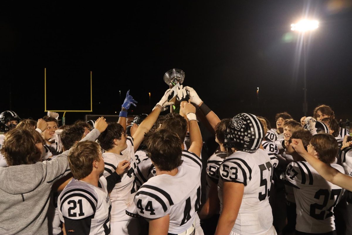 Lancers hoist the Mayor's Trophy after their win against against the Mustangs.