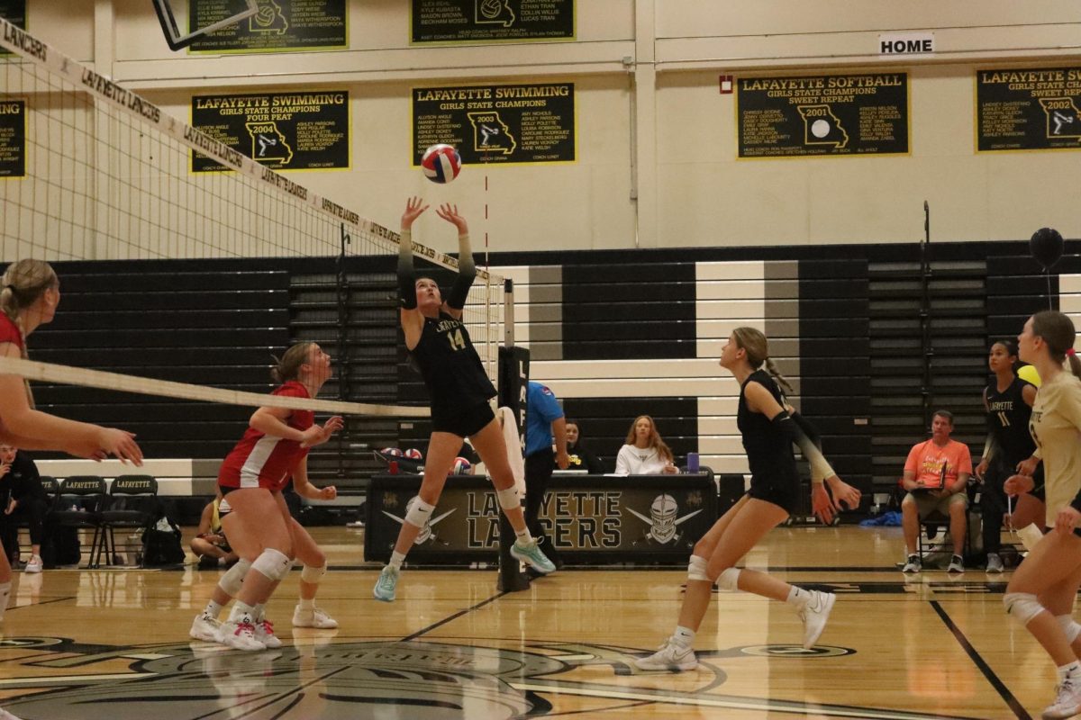 Senior setter Carly DeSarno sets the ball for senior middle blocker Kira Dufner.