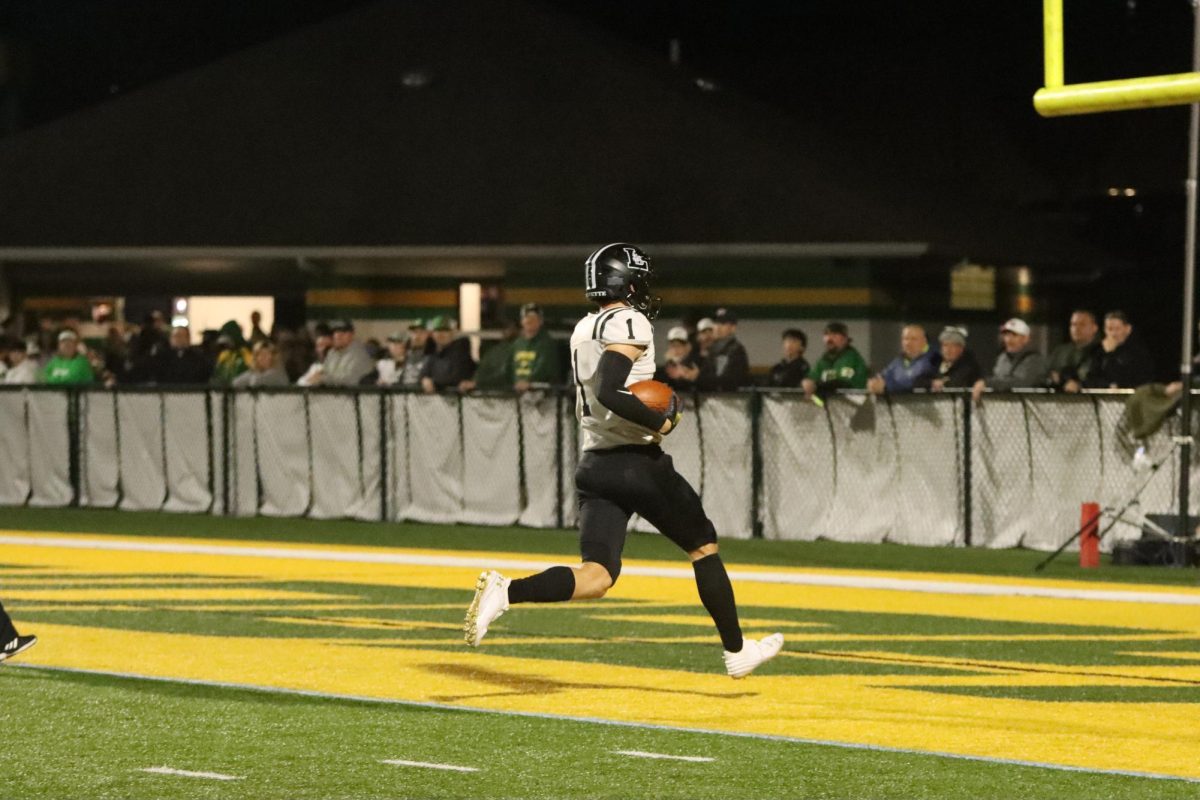 To score a touchdown, senior wide receiver Robby Preckel runs into the endzone. 