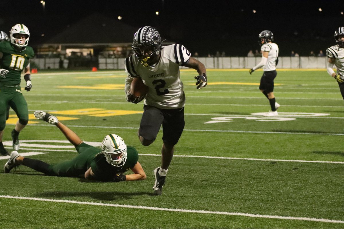 After breaking a tackle, senior running back Greg Robinson rushes towards the endzone.