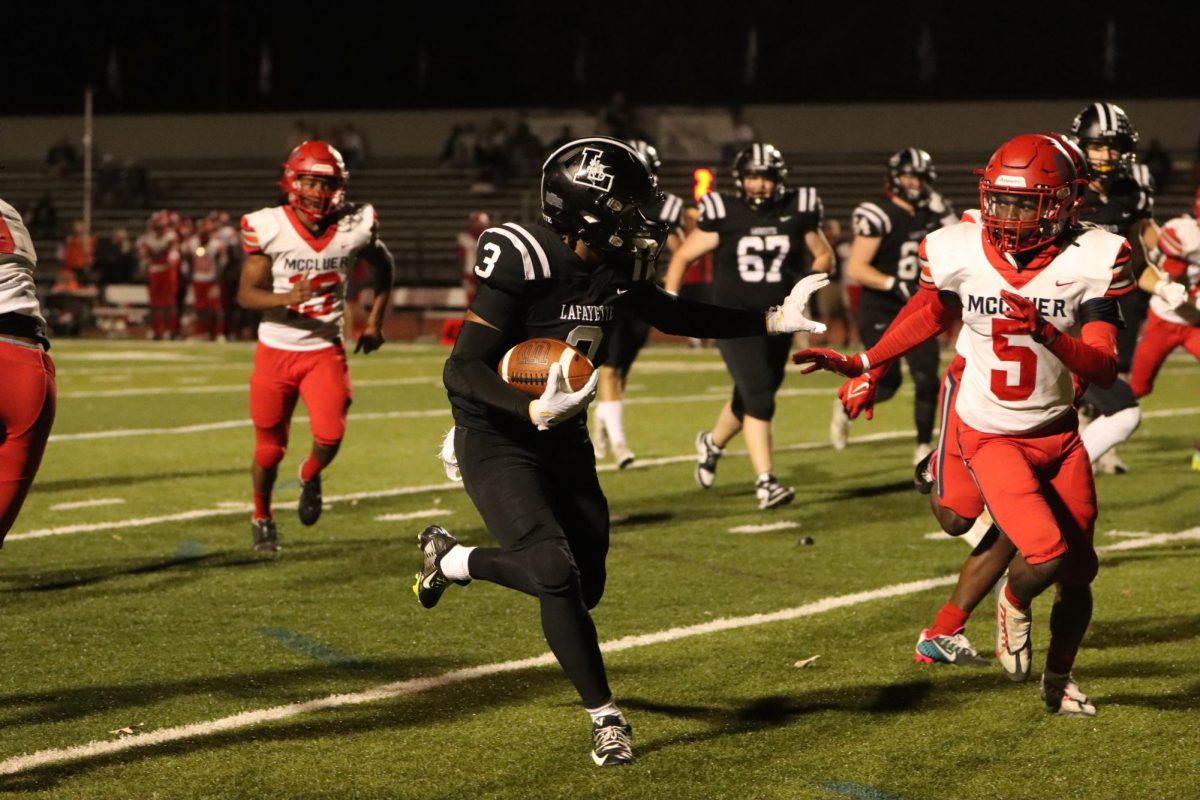 Rushing toward the endzone, junior Terrence Bills tries to stop a tackle. Bills finished the game with two touchdowns, as Lafayette won 55-0 against the McCluer, 