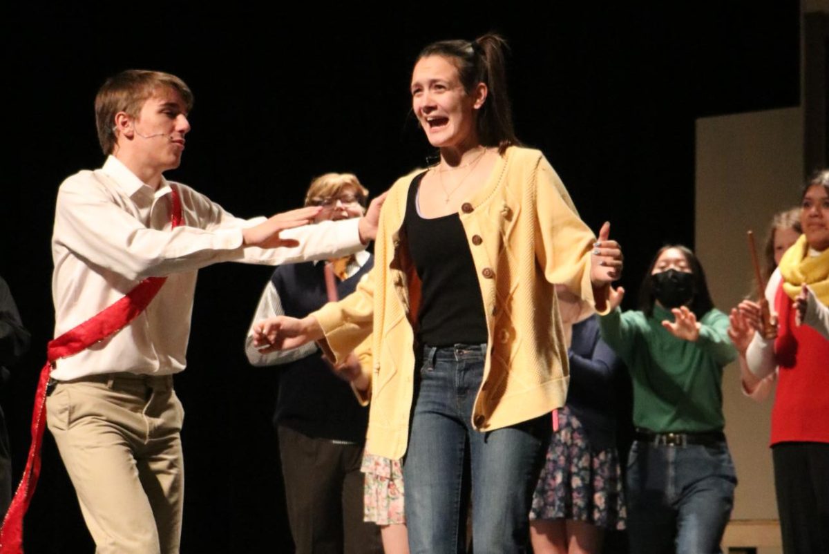 During their wet tech rehearsal, sophomore Lilly Colombo interacts with senior Blake Jaycox.