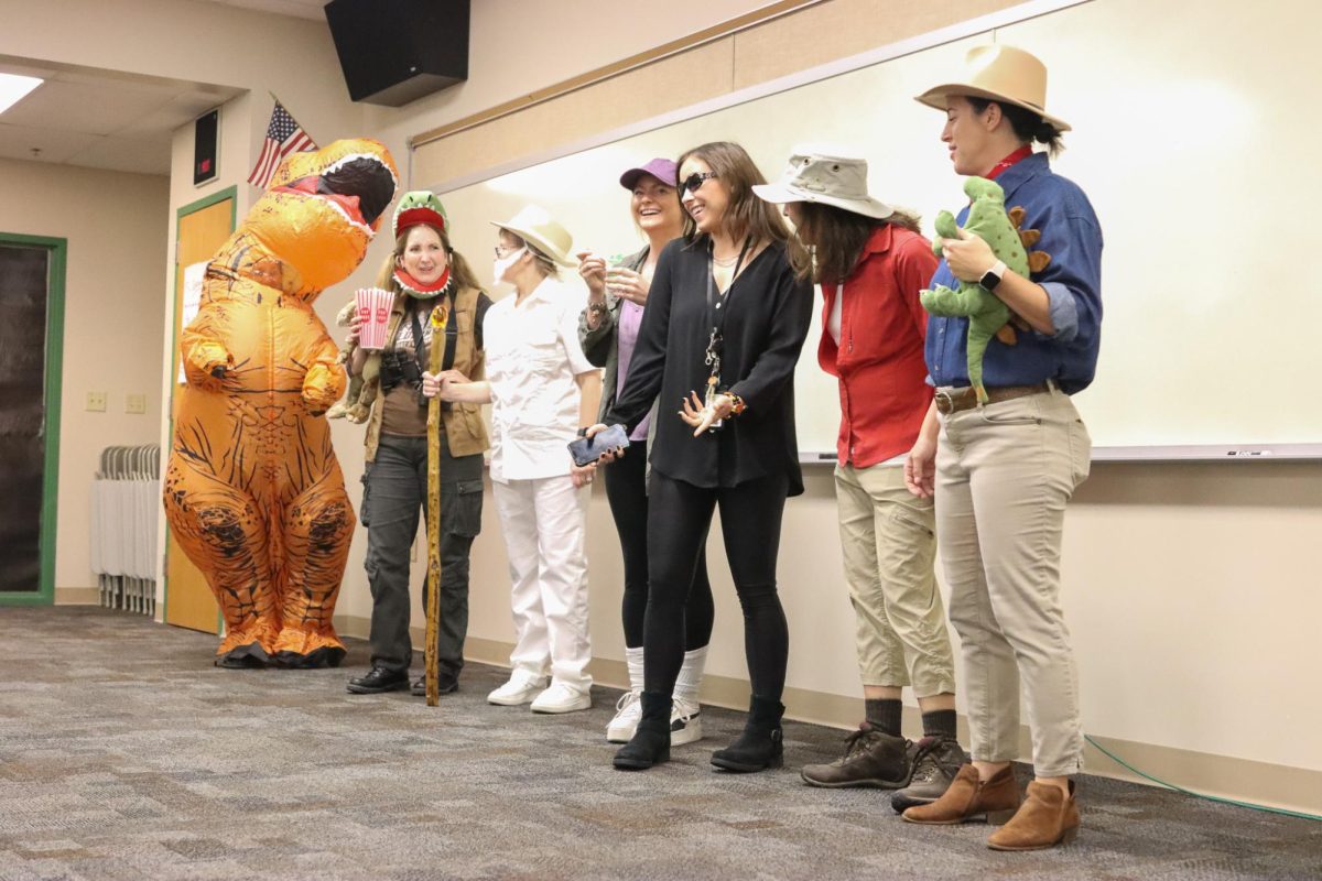 Complete with an inflatable dinosaur, counseling department staff dress as characters from "Jurassic Park".