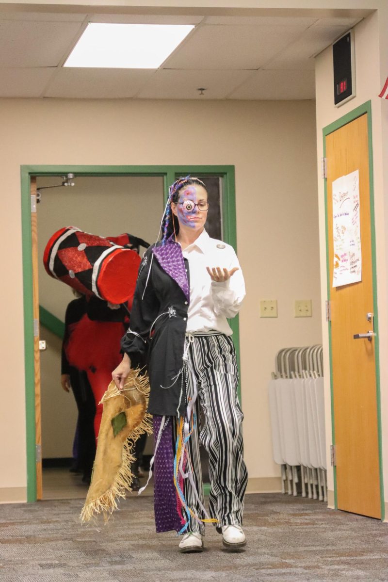 As she flips a coin, fine arts teacher Emily Benner dresses as DC villain Two Face. 