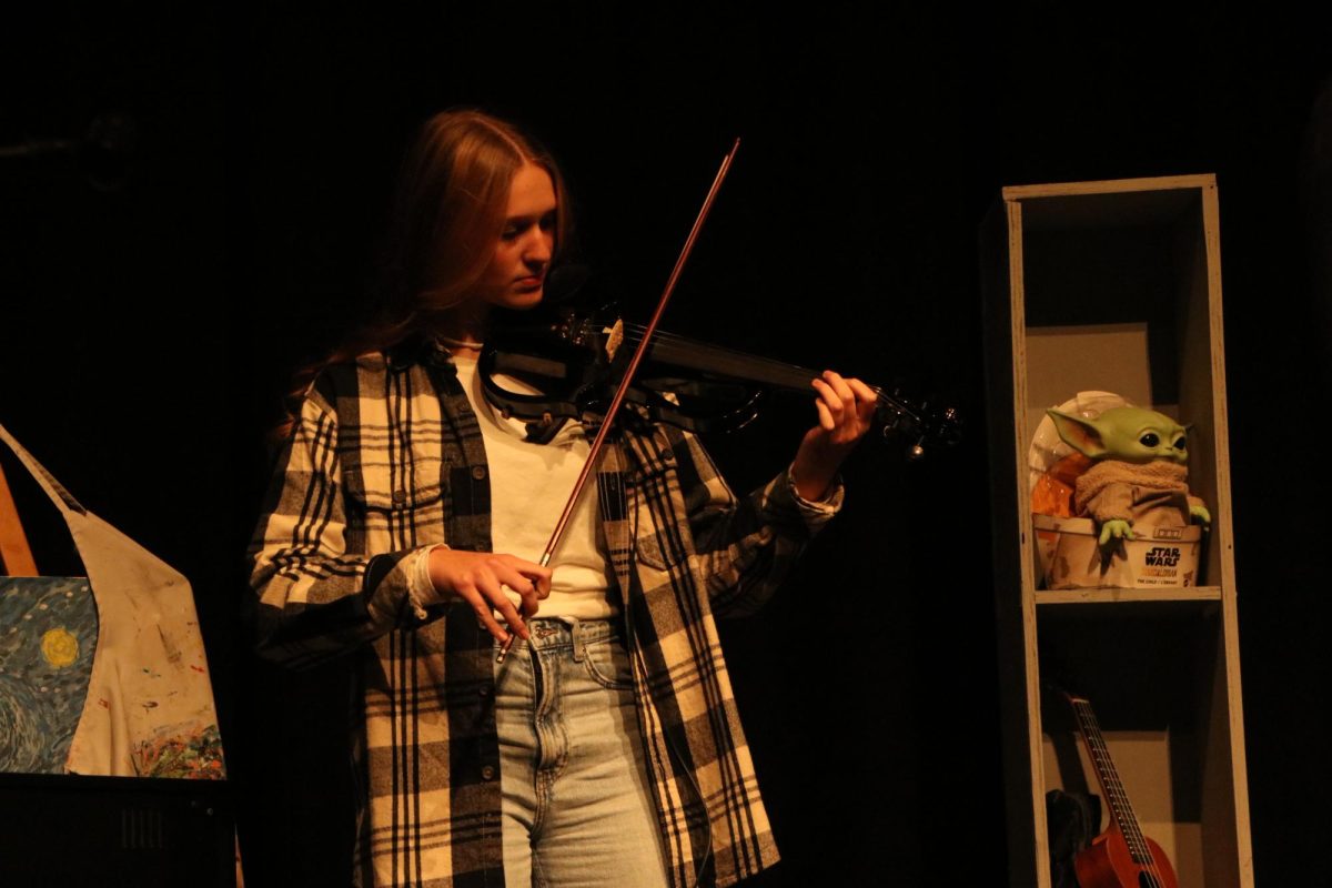 A member of "Funeral Potatoes," junior Hailee Roberts plays "Let Her Go" by Passenger on her violin.