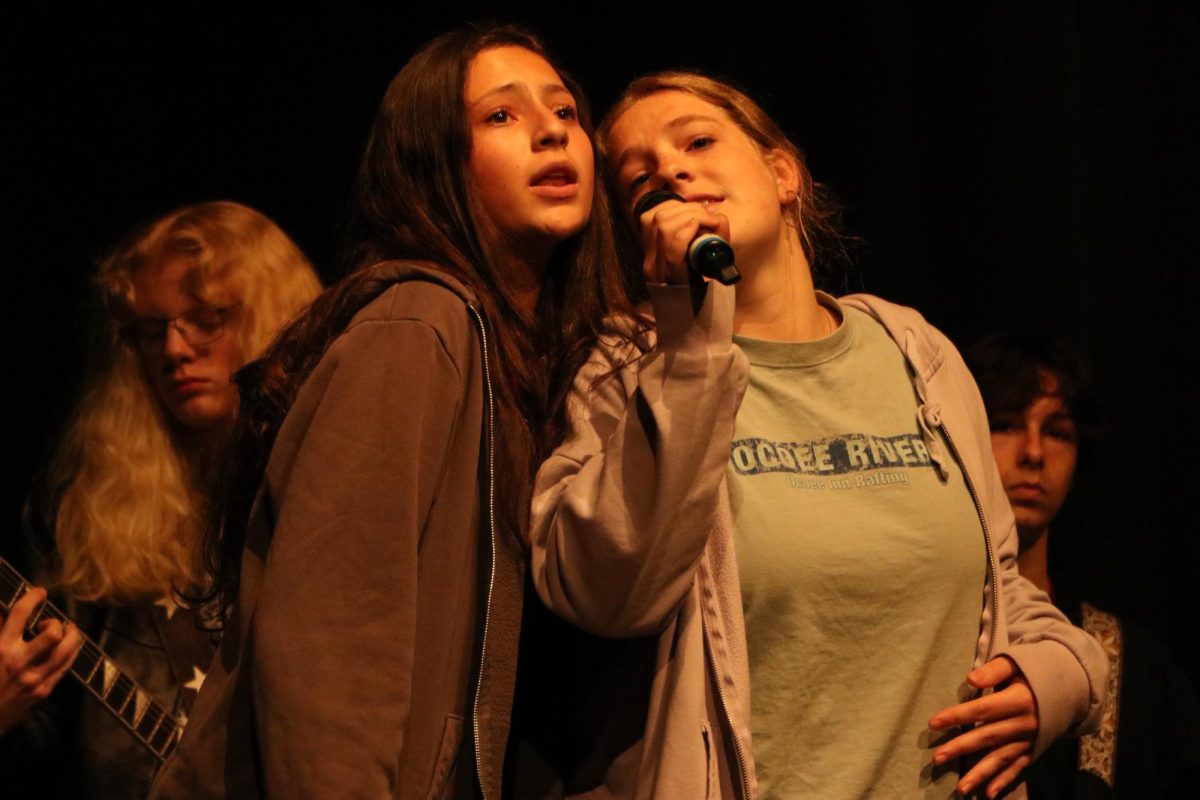 Sharing a microphone in the chorus, sophomores Hattie Kumar and Meghan McKee perform "Can't Stop" by the Red Hot Chili Peppers with their fellow Monday Jam Band members.