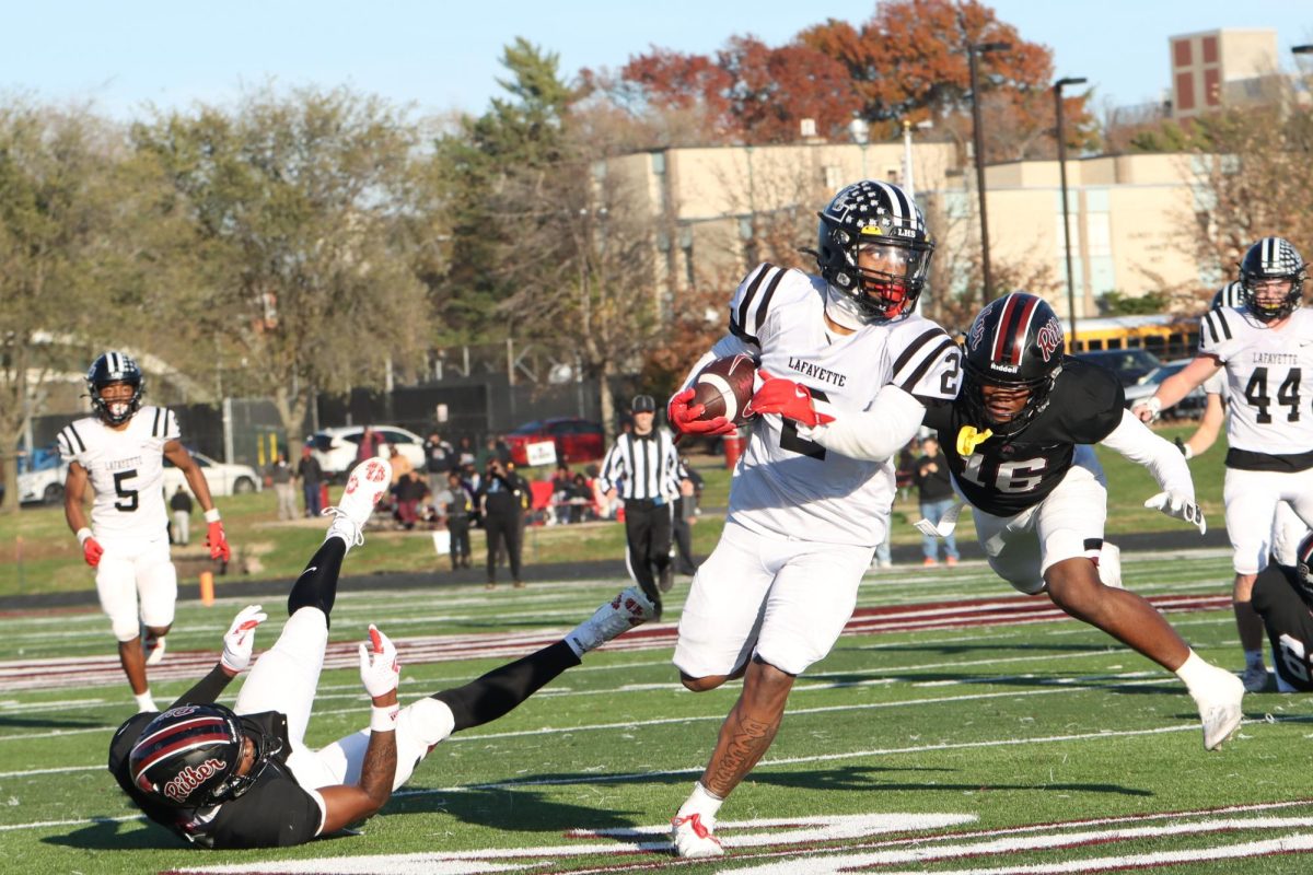 After an interception, senior linebacker Greg Robinson returns the ball. Robinson and the Lafayette defense made a big impact in the upset against Cardinal Ritter, Nov. 23.