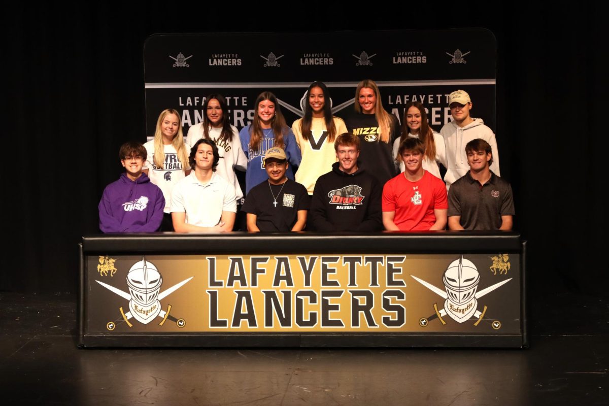 At the Fall College Signing day, 13 student athletes sign letters of intent in the Theater, Nov. 13. Family, teammates and coaches attended the event to support the signees. 