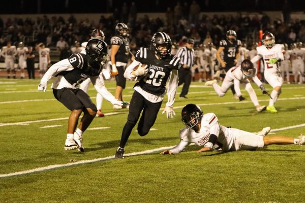 After a blocked punt, senior defensive back Drew Austermann runs the ball toward the Rockwood Summit endzone. The play was one of two defensive touchdowns by Lafayette