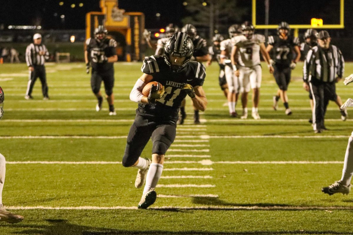 Senior receiver Jack Preckel runs the ball into the endzone for a touchdown.