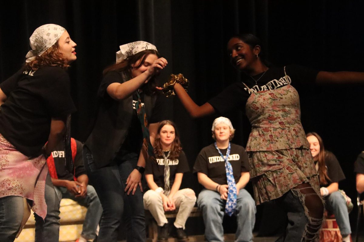 During the 7 p.m. show, sophomore Shruthi Senthil pretends to drive a car and ask for snacks from sophomore Mary Kirtley and senior Payton Skipton in the back seat. Undefined held two shows Nov. 22, and all proceeds went to STLSpark.