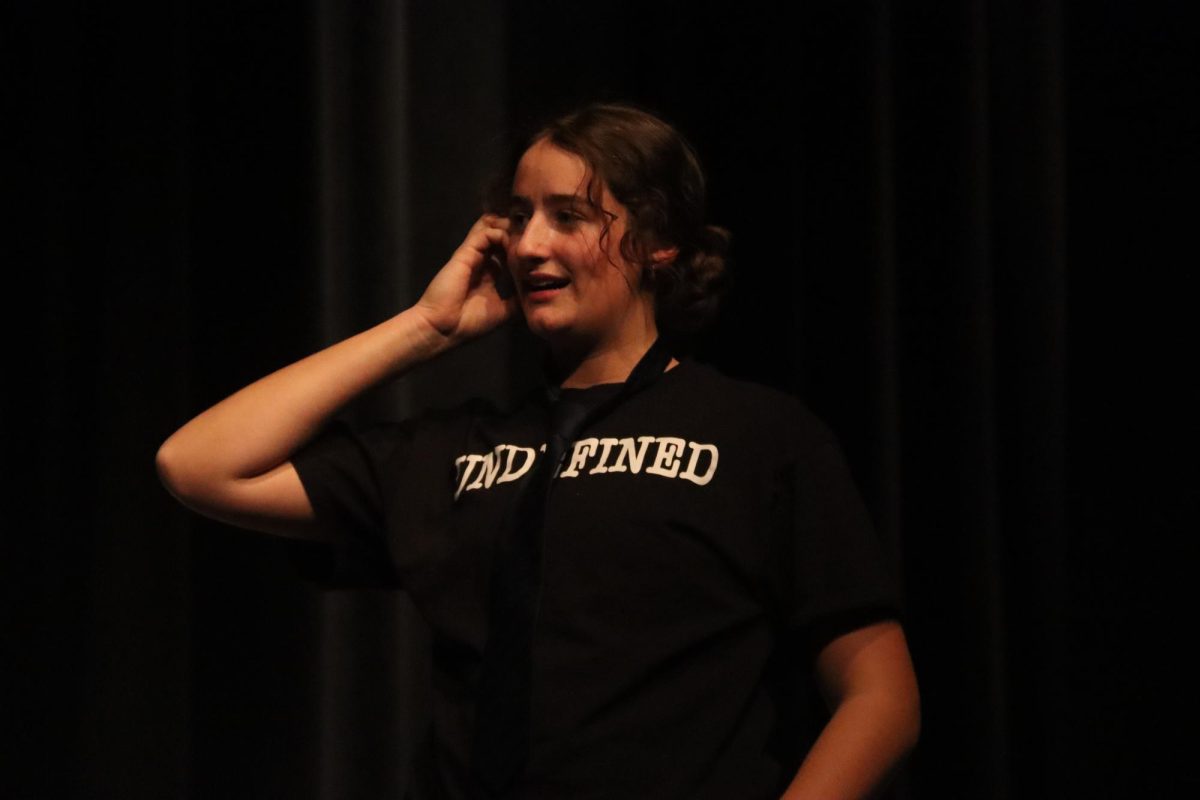 During a game of "Swinging Pendelum of Death," sophomore Annie Kirtley pretends to call someone. Members had to create three different scenes until everyone found a creative way to "die" in each scene.