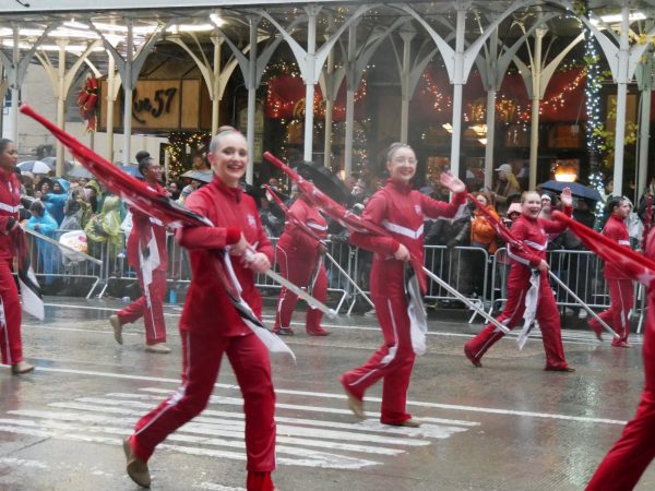 During the Macy's Thanksgiving Day Parade, the Macy's Great American Marching Band color guard was unable to spin on the parade route due to rain. Instead, color guard members were able to wave and talk with excited onlookers.

Photo Contributed By Gracie Hagen.