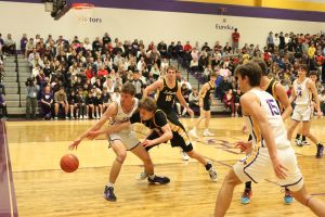 Senior Josh Pitney attempts to steal the ball from a Eureka player. The Lancers beat the Wildcats 51-49.