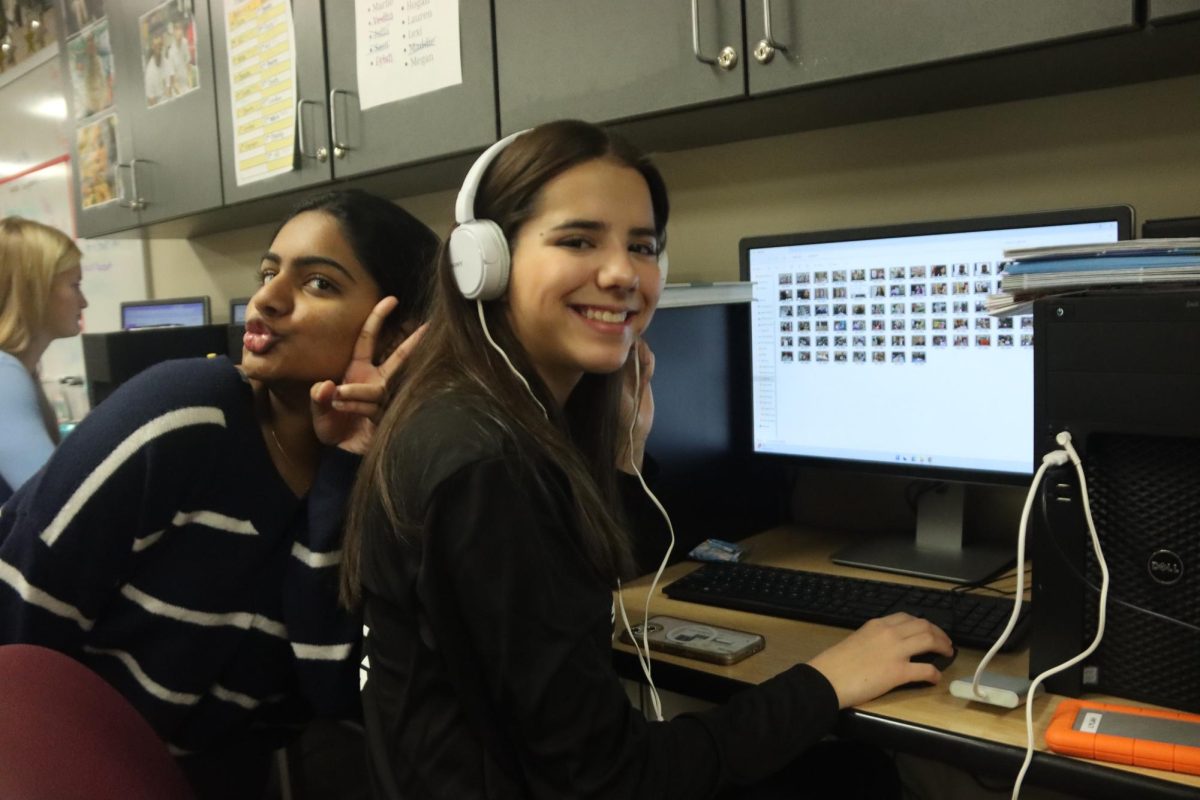 During Digital Media Production, 2024-2025 DM Editor in Chief Vedha Inampudi poses next to staff member Lylah Kimberlain as she edits a video.