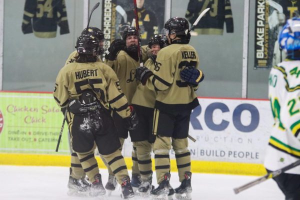 Lafayette skaters embrace after junior forward Addison Long's goal. This was Long's second goal of the night that propelled the Lancers to their 6-3 win, Friday.