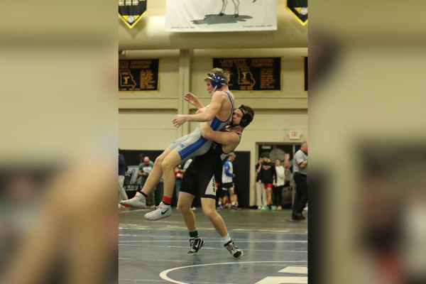 Senior wrestler Jeremiah Drake lifts opponent in the Lafayette "Fred Ross" Tournament. Drake won his match and finished first at the tournament.