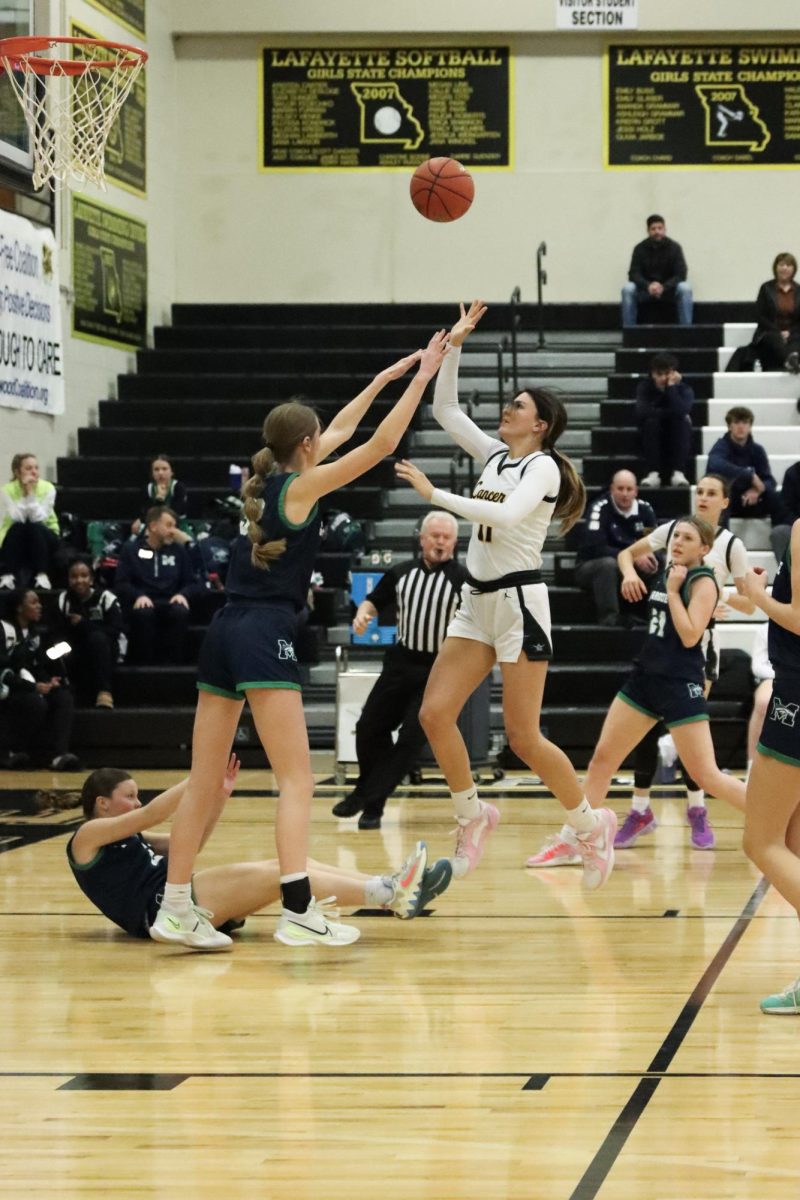 With a hand in her face, senior forward Taylor Nania shoots the ball. The Lancers finished the game losing, 38-64.